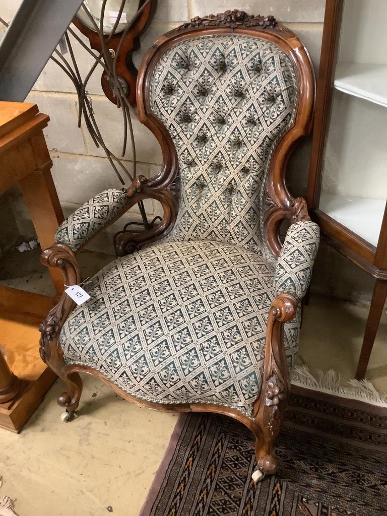 A Victorian carved walnut open armchair, width 66cm depth 75cm height 96cm